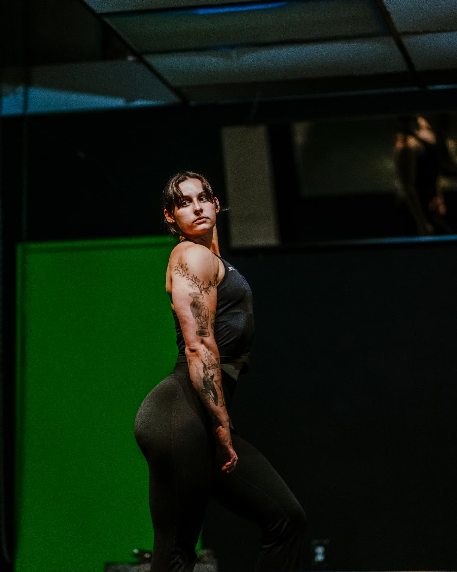 Gillian standing in a dark gym after a strength session