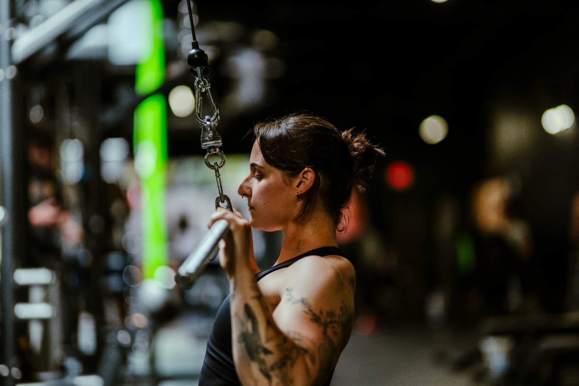 Gillian training on a cable machine in a dark gym
